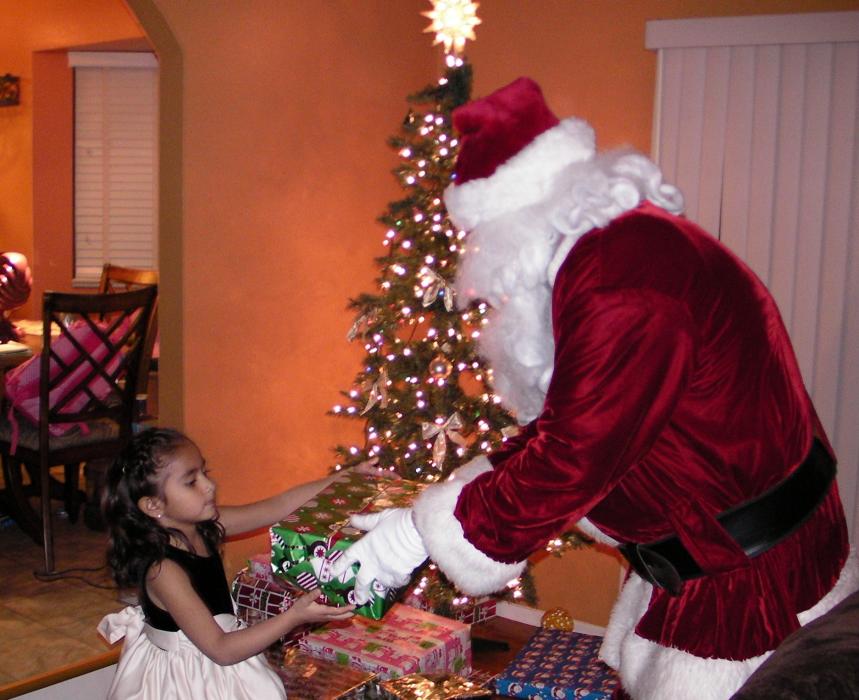 Brianna Garcia, 4, accepts a gift from Santa.