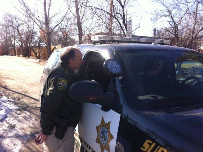 Sheriff Ken Furlong speaks to Sgt. Mike Cullen near the Carmine residence.