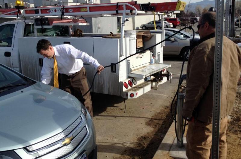 Officials test the electric vehicle charging station at Mills Park.