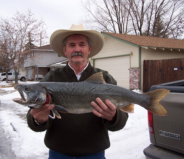 Michael Flanagan of Douglas County holds his 10-pound Mackinaw Trout caught while ice fishing at Caples Lake.