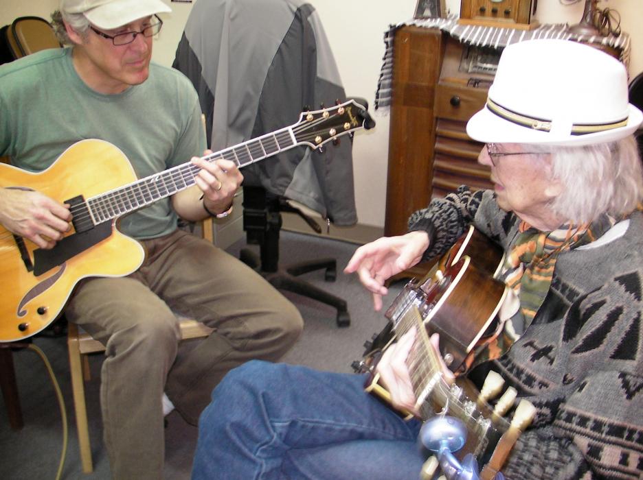 Steve Root gets a lesson from guitar instructor Jacki Montgomery.