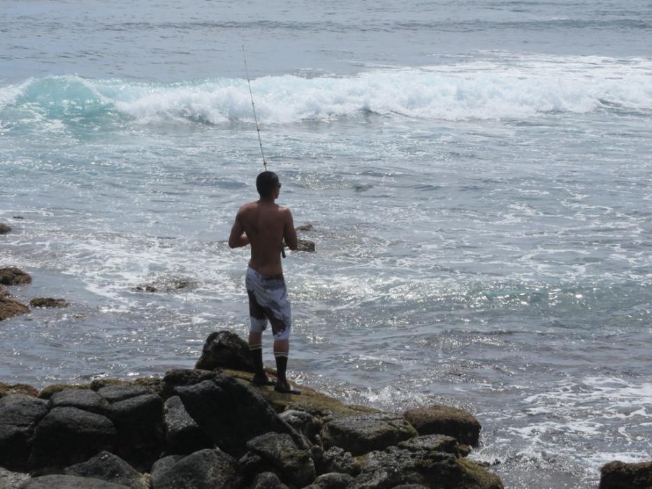 Surf fisherman at Lawii Beach on Kauai, Hawaii. Photo by Elaine Quilici