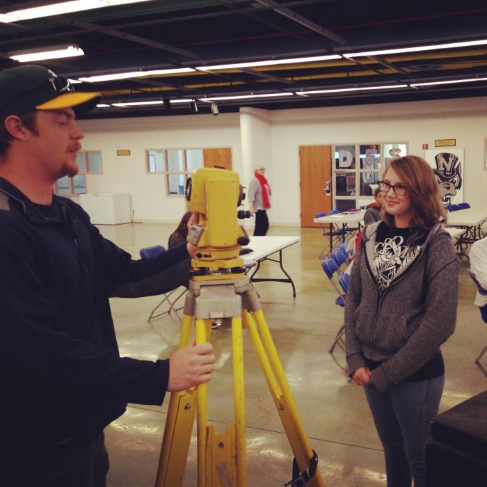 AACT student Alissa Lavelle speaks with University mining engineering student Jay Dewald about different equipment used.
