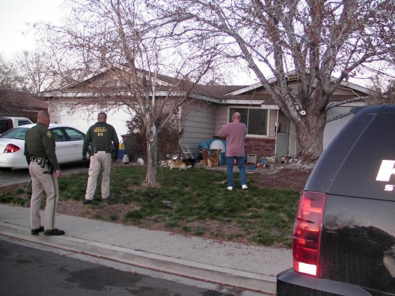 Carson City Sheriff's Office deputies and a health officer inspect the home Thursday.