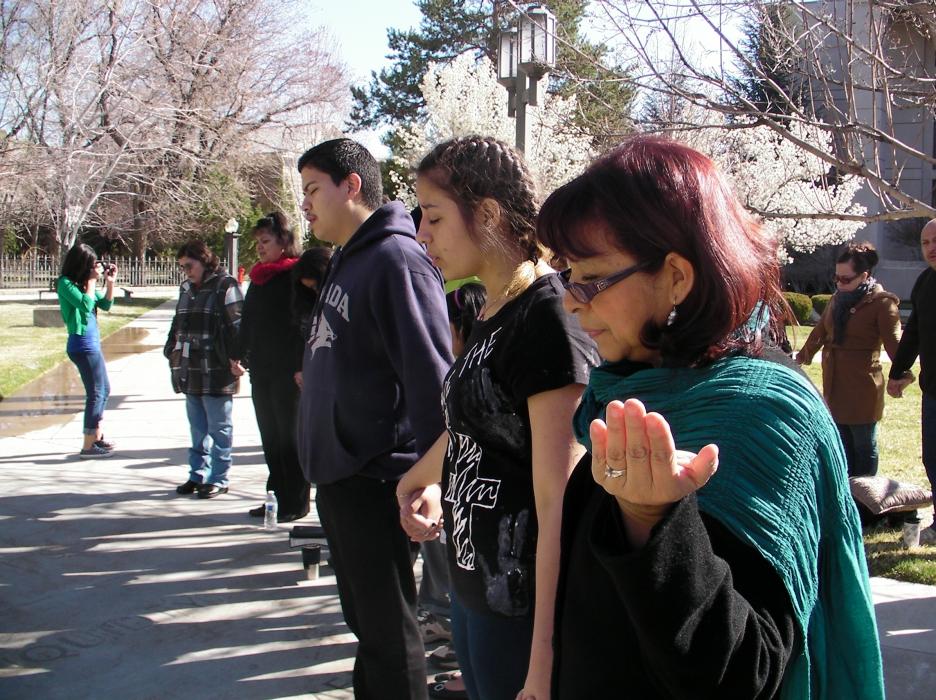 Martha Coscarart, Becky's mentor for the senior project extends her hands in prayer.
