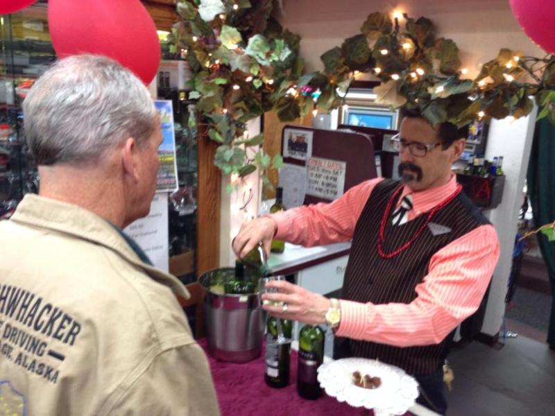 Mark Schmidt of Carson Jewelry and Loan pours some wine during Saturday's Wine Walk.