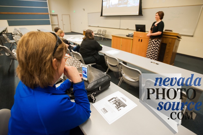 Jennifer Chandler records her daughter, Emily Chandler, as she gives her presentation to UNR judges.
