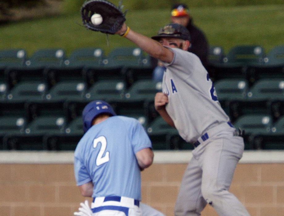 First baseman Spense Dorsey holds the runner at first.