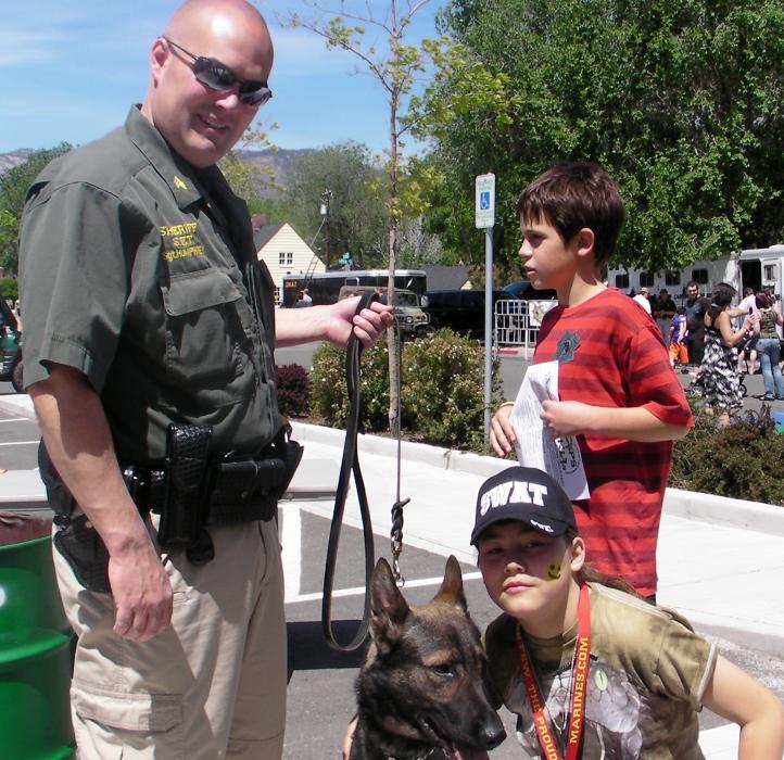 Sgt. Brian Humphrey and K9 Ivo team up for a photo with Christiana Faith.