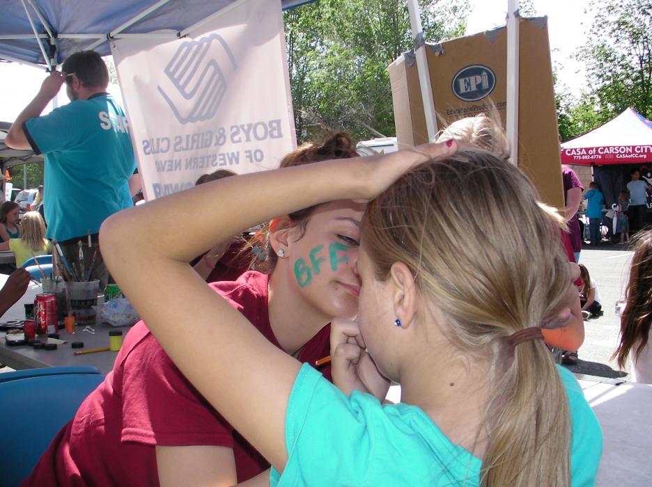 Boys and Girls Club volunteer Mackenzie Malone prepares young face to paint.