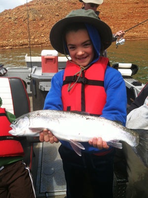 A happy, young fisherman with a King Salmon caught at Shasta Lake, Calif.