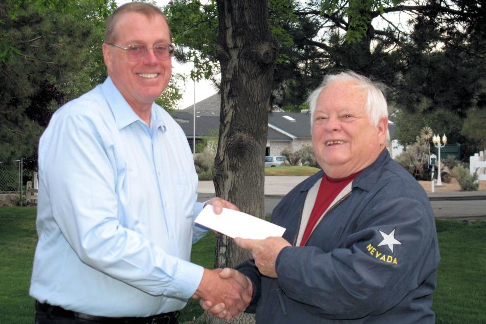 Carson City Assemblyman Pete Livermore, right, presents a donation to Tom Porada.