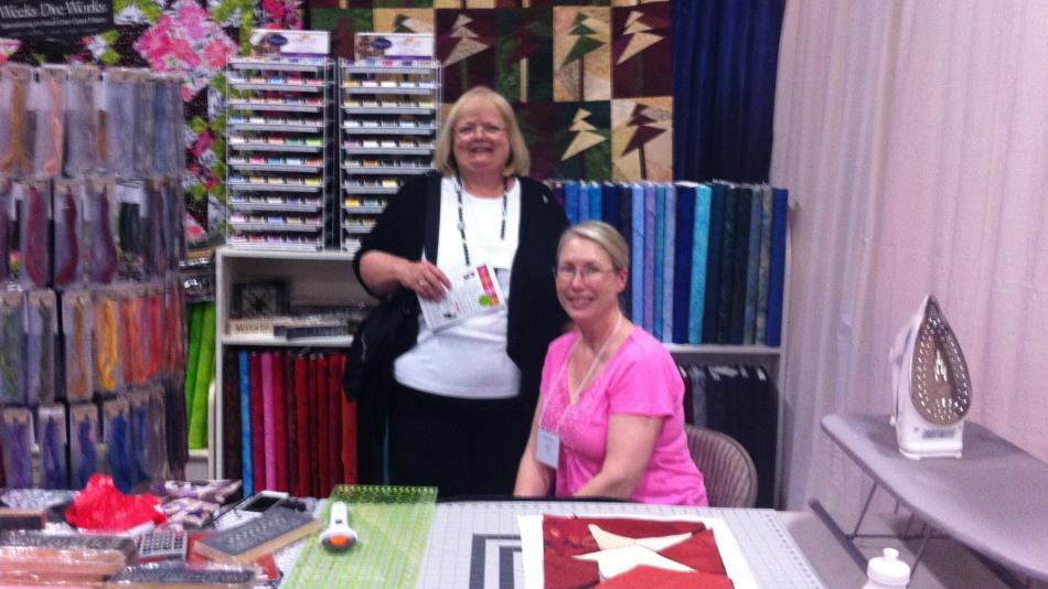 Debbie Pastini (left) and Maggi Davis (right) working at their booth