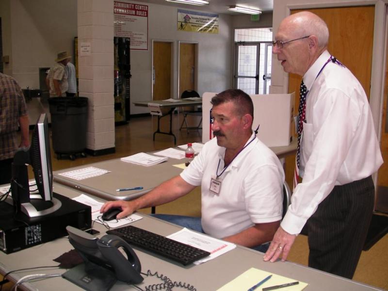 Elections volunteer Mike Mead, left and Carson City Clerk-Recorder Alan Glover look at the voting numbers.
