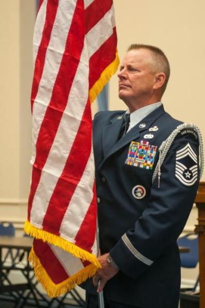 Chief Master Sgt. Greg Bartlett displays the American flag during the Nevada Guard Flag Day ceremony in Carson City on Friday.