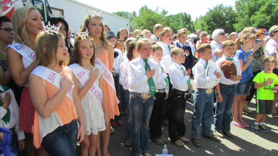 Regional beauty queens and 4-H kids recite the Pledge of Allegiance at the grand opening of the NV150 Fair.