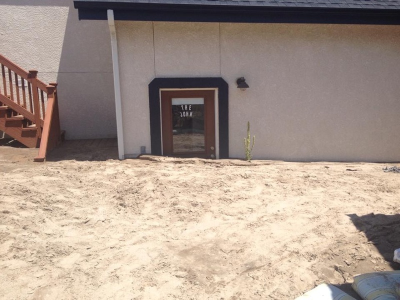 The devastation from the flash flood on July 20, 2014. Mud and settlement is half way up the door.