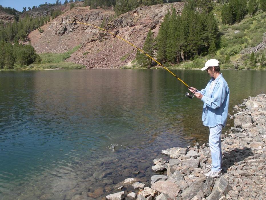 Elaine Quilici catching a small Brook Trout.  Photo by Don Quilici