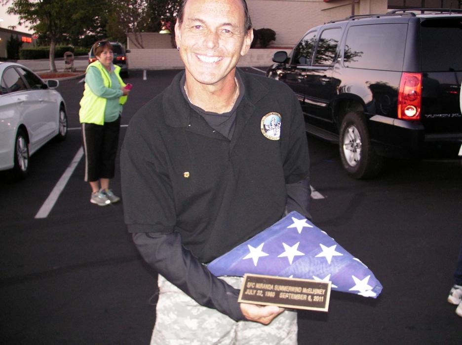 Ken Curtzwiler, father of McElhiney, with a remembrance flag.
