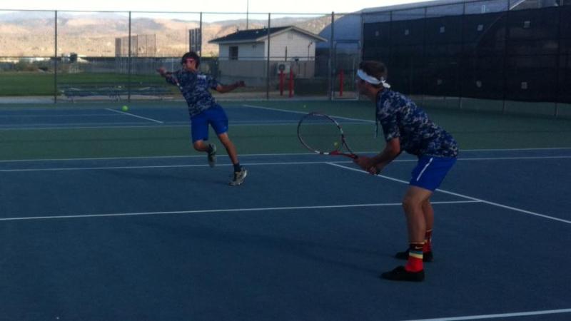 Aaron Woodbury hits a backhand volley