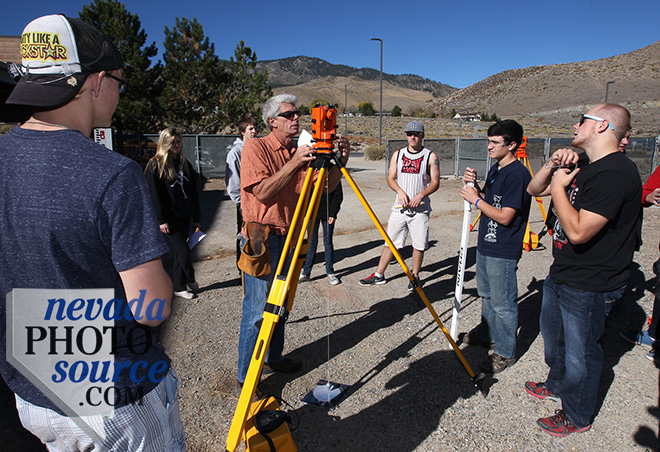 Don Boebel, center, demonstrates surveying equipment for a group of Silver Stage High School students. Photo by Cathleen Allison