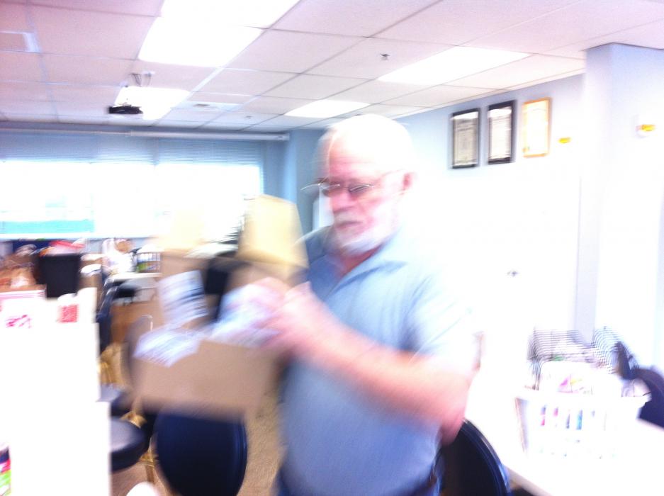 Verne Horton, Vice President of the Fleet Reserve 137 prepares to load a box.