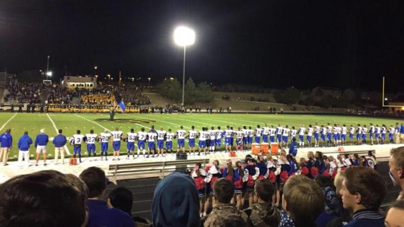 The Carson fans and players during the National Anthem.