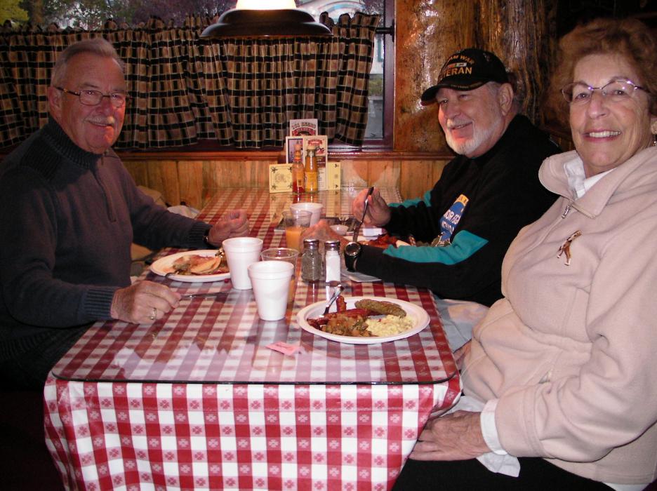 Ron Smith, right, Roger and Sharon Diez enjoy their pancake breakfast.