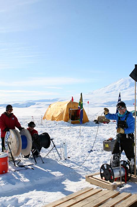 UNR Professor Scott Tyler, right, unspools fiber optic cable in Antarctic’s Ross Ice Shelf.