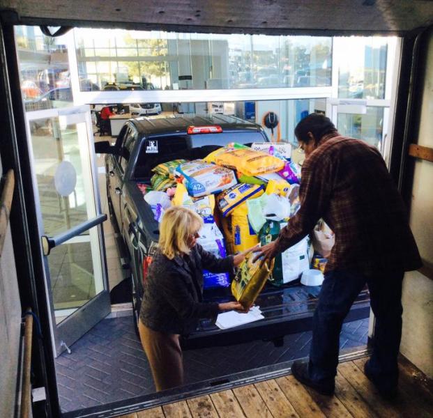 Pets of the Homeless representative and FISH Food Bank Manager load up FISH truck.