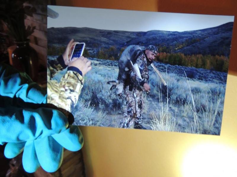 A game warden holds a photo discovered while executing a search warrant.