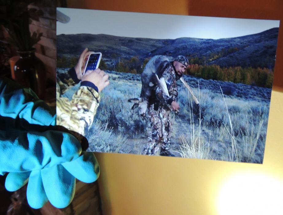 A game warden holds a photo discovered while executing a search warrant.