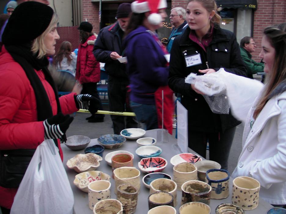 Bonnie Easler talks to volunteers Amanda Singleton and Rene Moriarty.