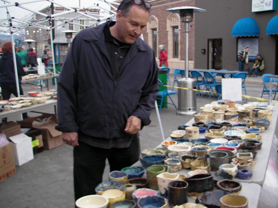 Jim Peckham, executive director of FISH, looks for a bowl he wanted before Friday's setup.
