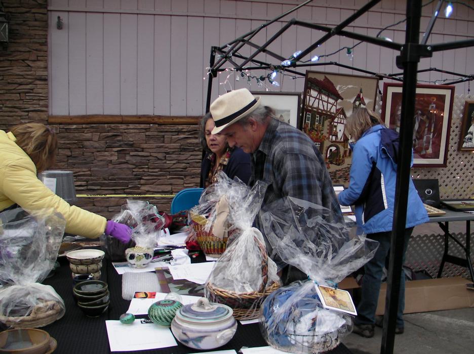 Rich McGregor going through the donations at the Empty Bowls Project silent auction.