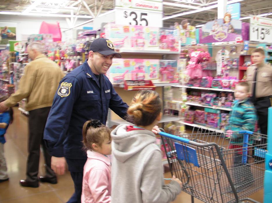 Home for the holidays from Kodiak, Alaska, Austin Bartosz takes two children shopping.