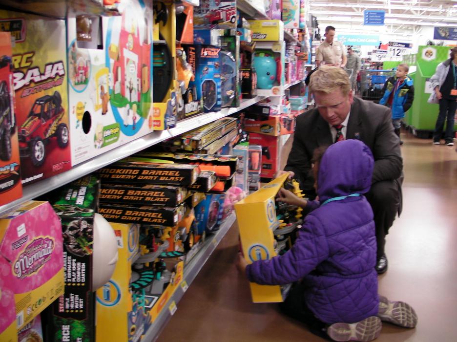 Carson City District Attorney elect Jason Woodbury helped this girl pick out a toy, shoes and clothing.