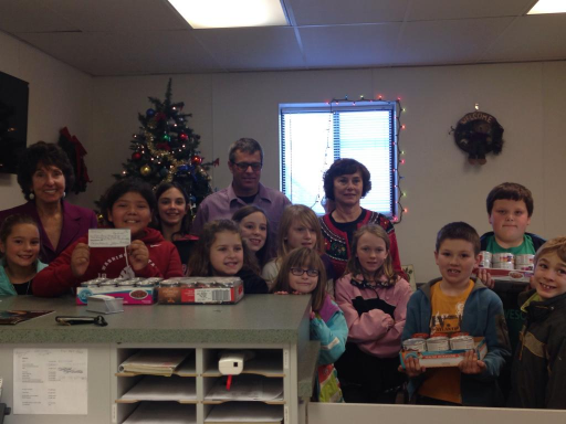 Staff and students from Carson Montessori School bring holiday cheer to Humane Society.