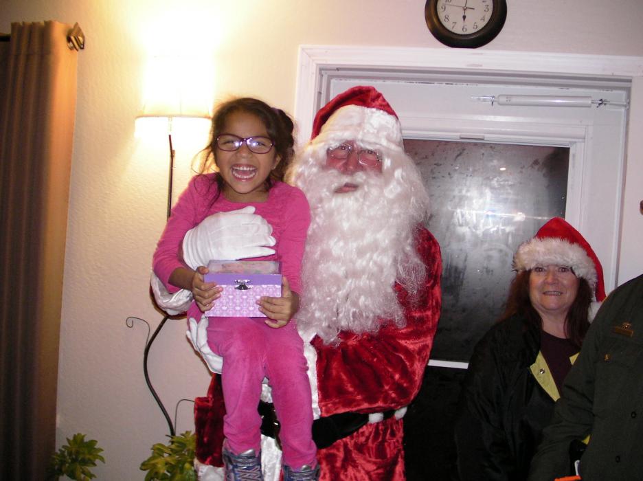 Dylan Reyes, 8, gets a lift from Santa.