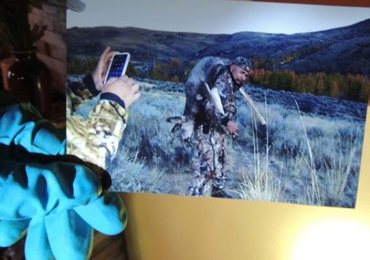 A Nevada Department of Wildlife game warden holds a photo discovered while executing a search warrant.