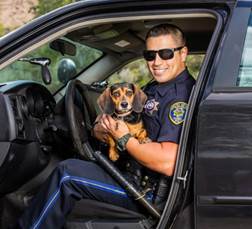 Reno Police Officer AJ Barba posing for the 1st 2015 Pets on Patrol calendar.