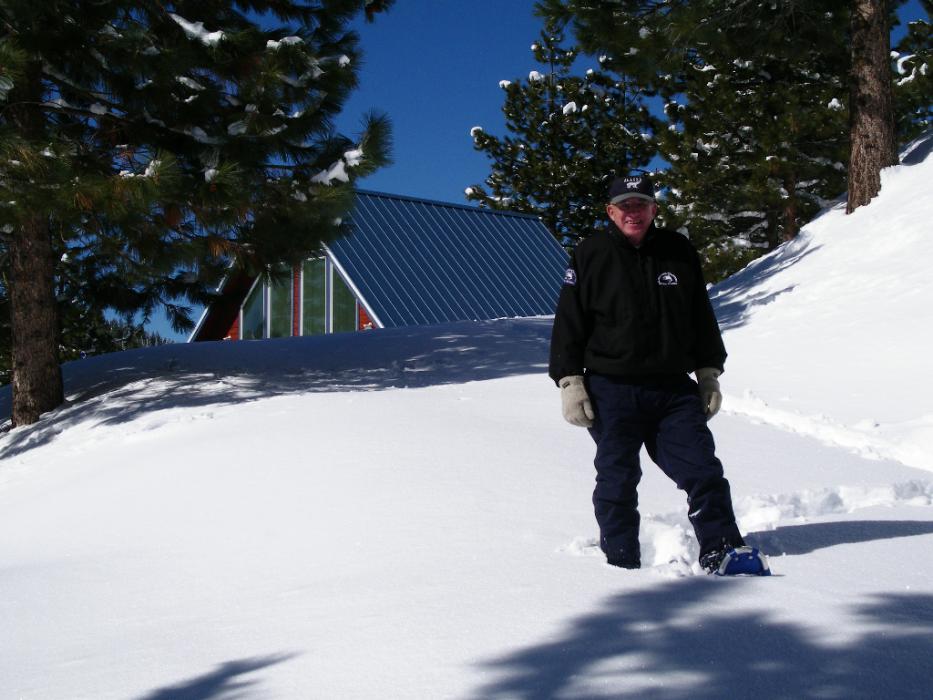 Don snowshoeing past a mountain home on Feb., 20, 2011.  Photo by Elaine Quilici