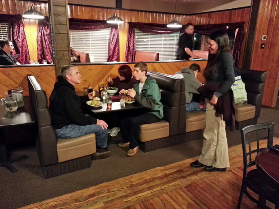Mike Ball and family of Carson City dine on Sassafras favorites as Kristy Moser, right, stops by the table to greet her friends.