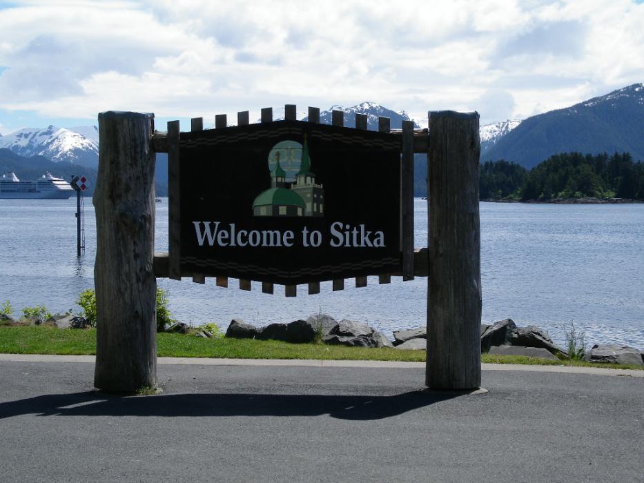 Welcome to Sitka sign with a cruise ship in the background. Photo by Elaine Quilici