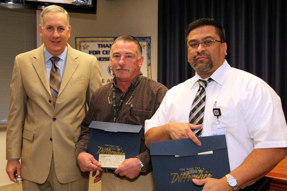 NDOT Assistant Director of Engineering John Terry (left) presents award to Kurt Garret (center) and Oscar Fuentes.