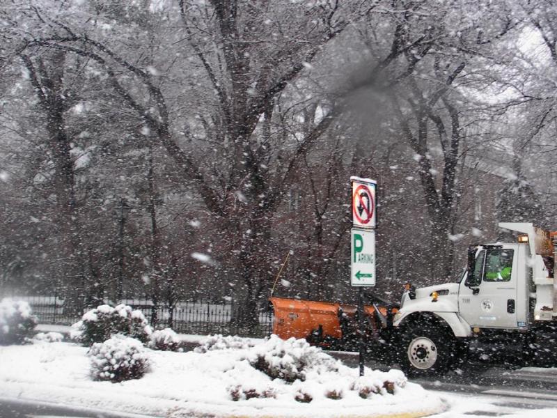 A snow plow whisks past the Nevada Legislative Building on Saturday.