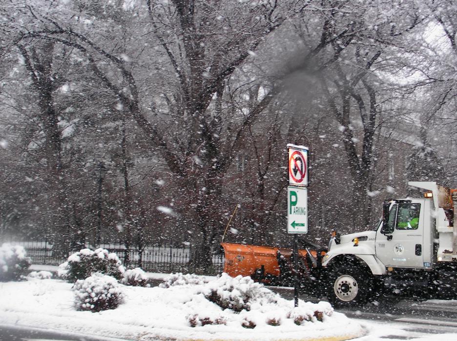 A snow plow whisks past the Nevada Legislative Building on Saturday.