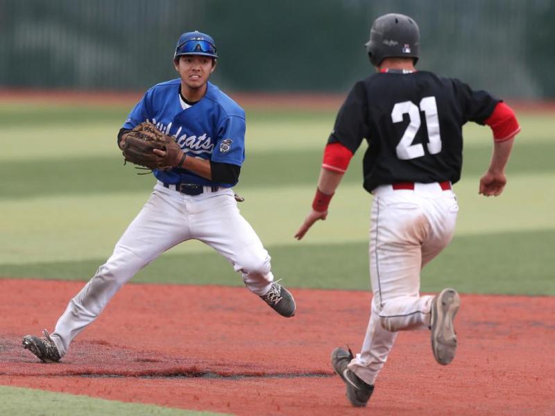 Wildcats' David Modler tags out Mt. Hood's Louis Wolf during a game Friday in Carson City. Cathleen Allison, Nevada Photo Source