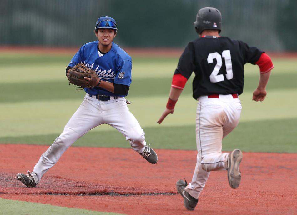Wildcats' David Modler tags out Mt. Hood's Louis Wolf during a game Friday in Carson City. Cathleen Allison, Nevada Photo Source