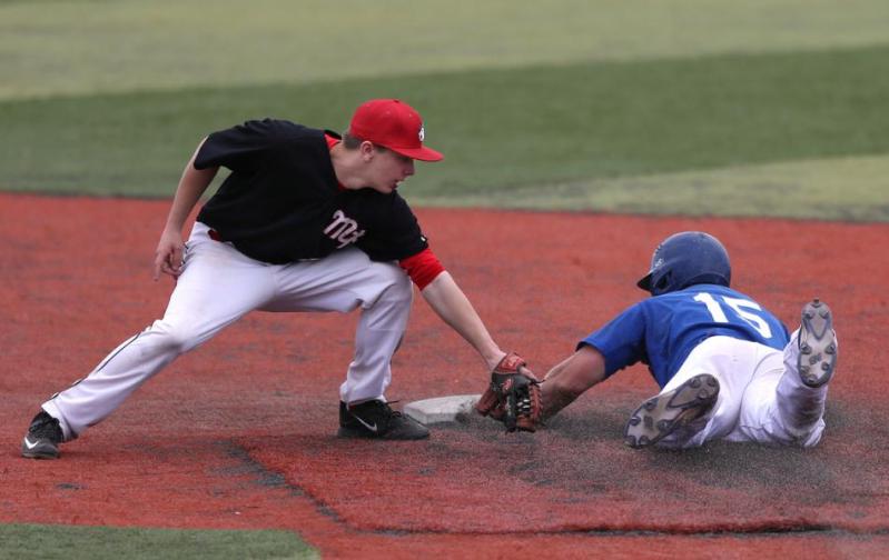 Wildcats' Jake Bennett steals safely Friday under the tag of Mt. Hood. Photo by Cathleen Allison